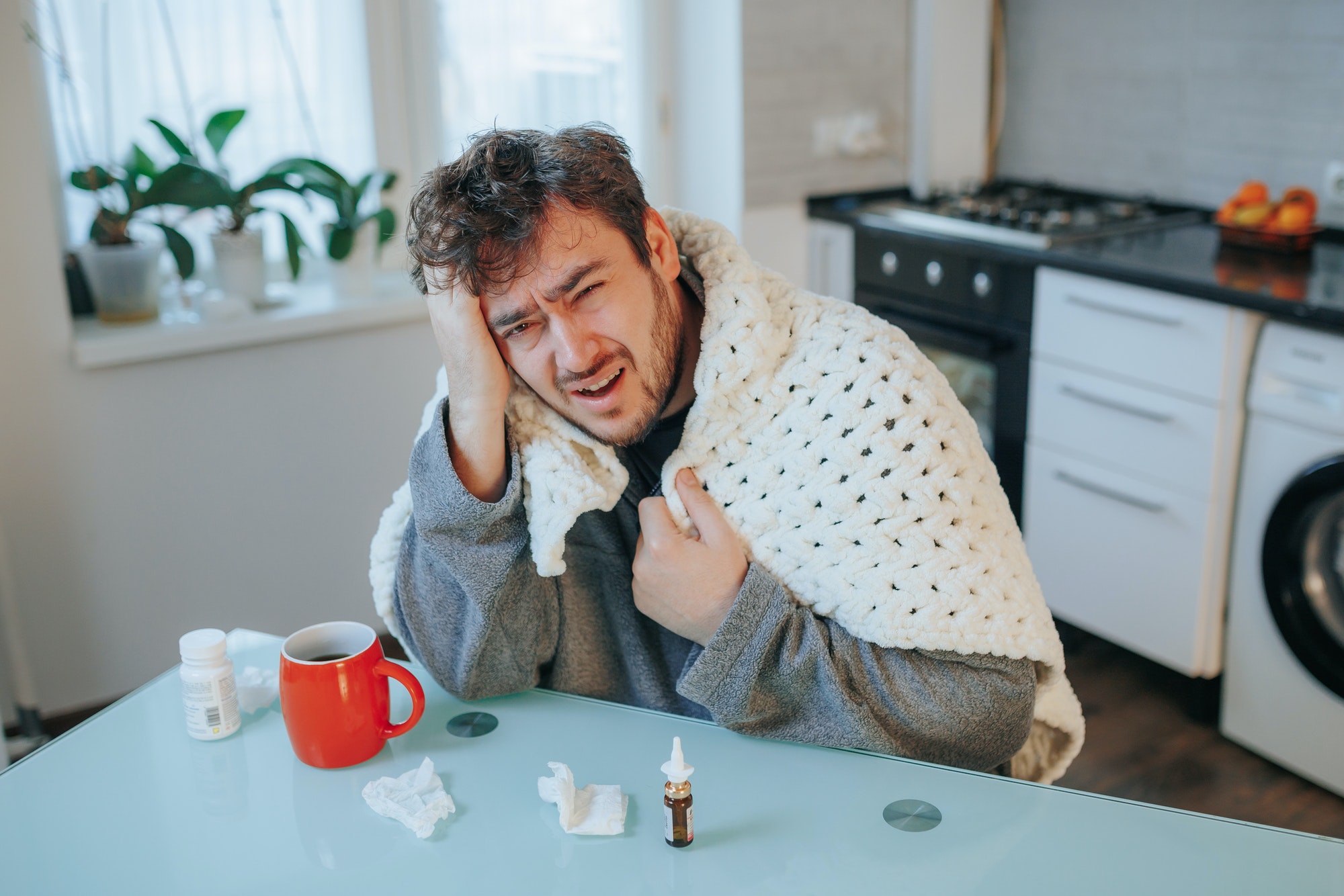 True to Life Image Stressed Man Battles Flu, Headache on Kitchen Chair